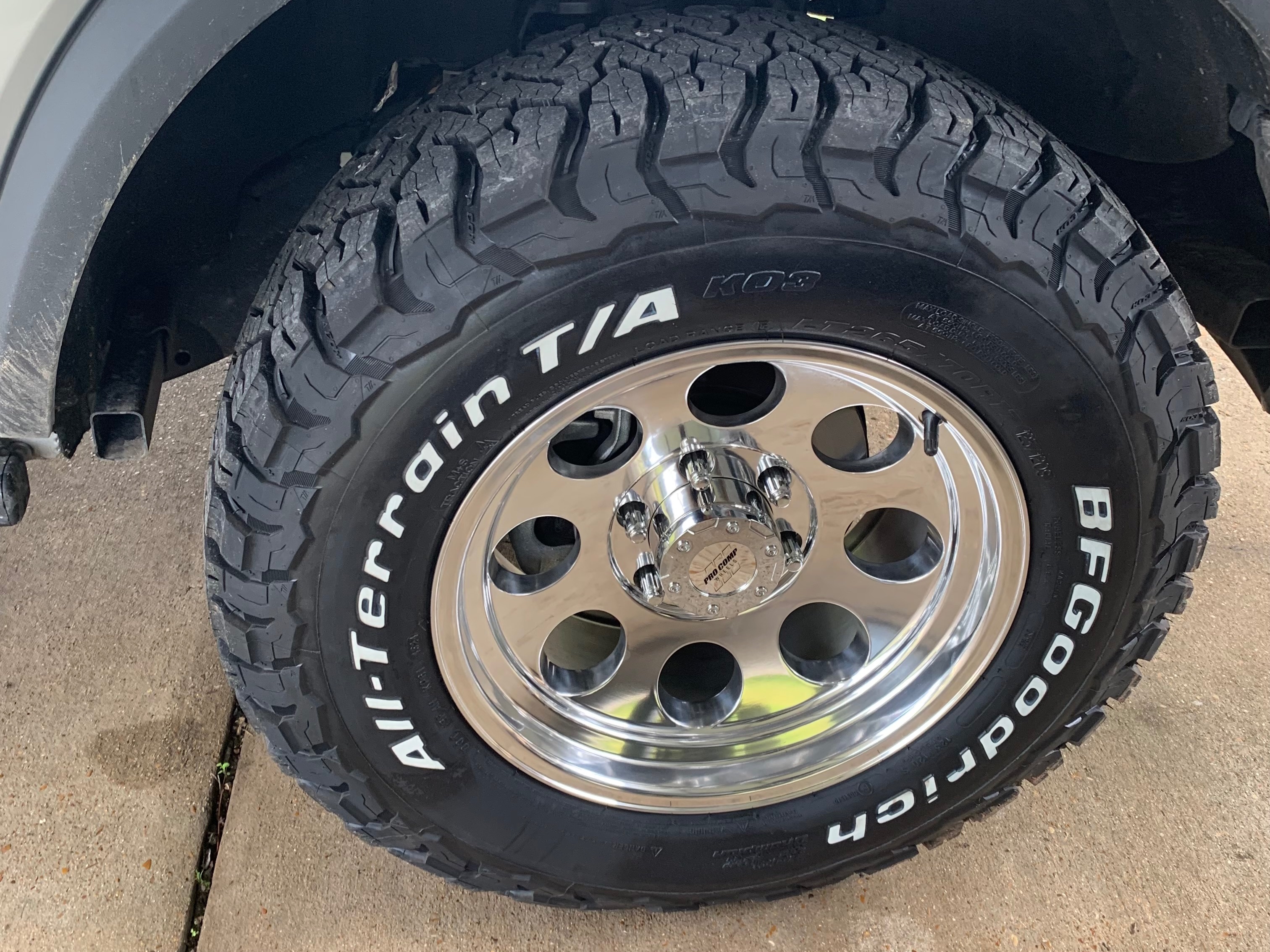 BFGoodrich All-Terrain T/A KO3 tire mounted on a polished chrome wheel, shown in a close-up view on an off-road vehicle.