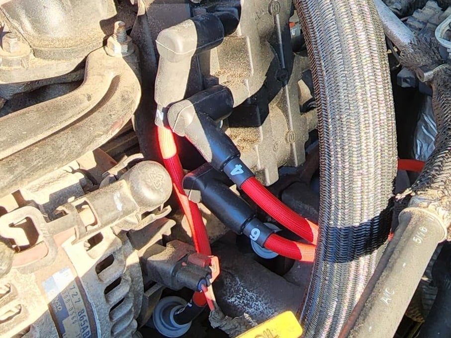 Comparison infographic showing an iridium spark plug and a platinum spark plug, labeled to highlight the two common spark plug types used in automotive ignition systems.